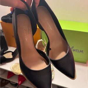 BCBGeneration Black Pointed Toe Pumps with Gold Trim Chain Accent